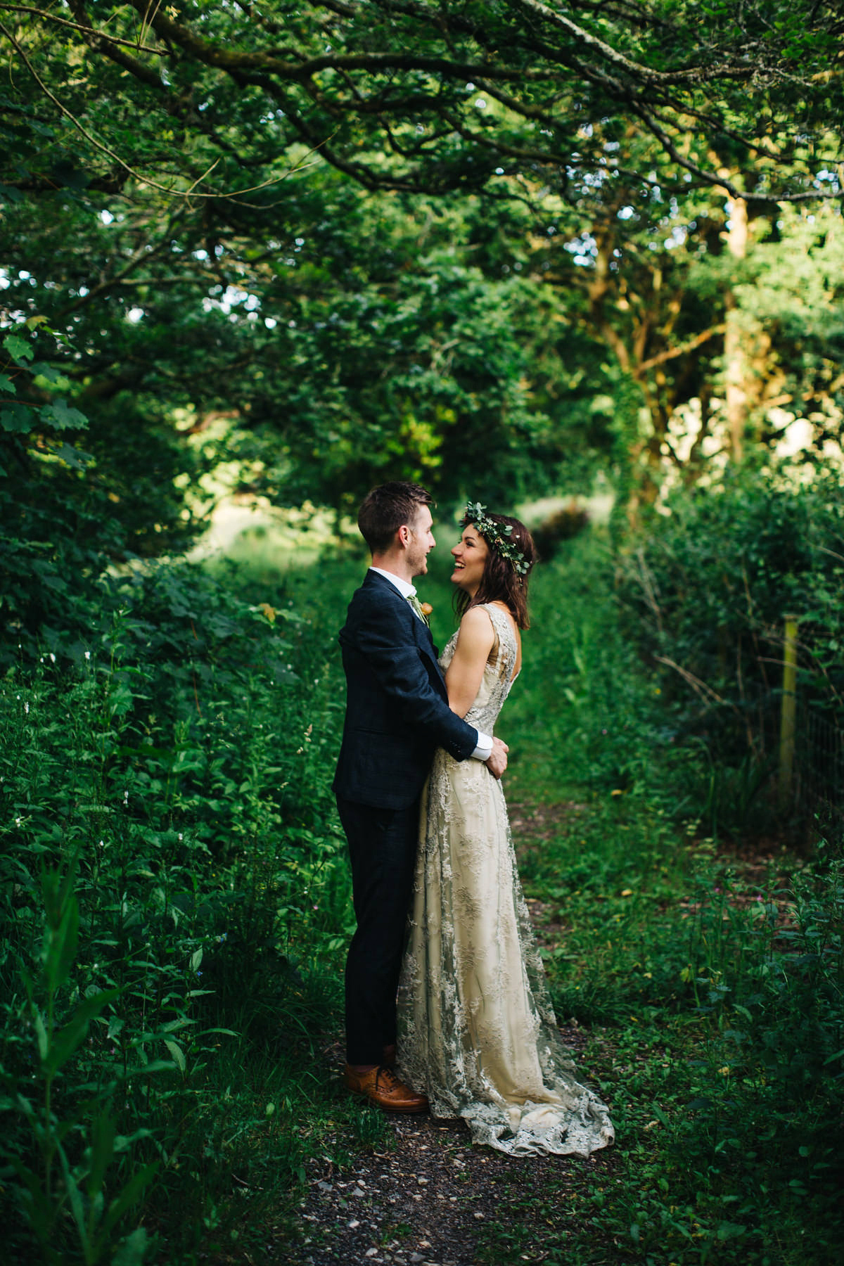 Boho bride Alice wore a pale green lace wedding dress and floral crown for her wild woodland inspired, free spirited South Devon wedding at Langdon Court. Photography by Richard Skins.