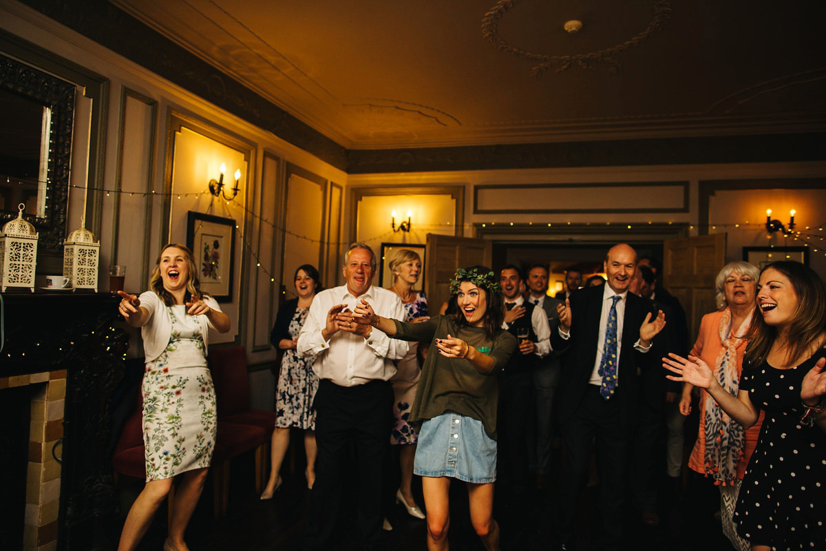 Boho bride Alice wore a pale green lace wedding dress and floral crown for her wild woodland inspired, free spirited South Devon wedding at Langdon Court. Photography by Richard Skins.