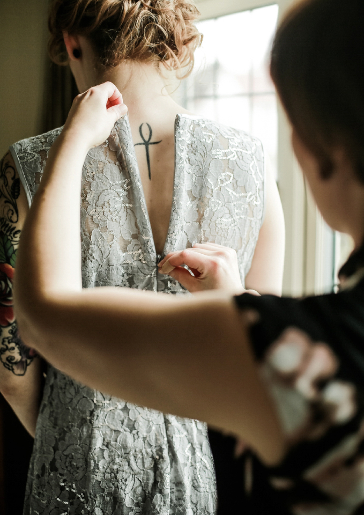 Gillian wore a short lace John Lewis wedding dress and a feather in her hair for her nature inspired Autumn wedding at London Wetlands Centre. Images by Kristida Photography.