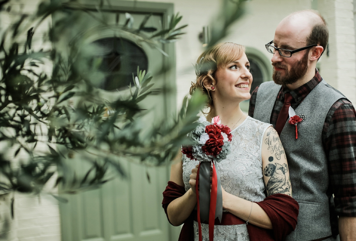 Gillian wore a short lace John Lewis wedding dress and a feather in her hair for her nature inspired Autumn wedding at London Wetlands Centre. Images by Kristida Photography.