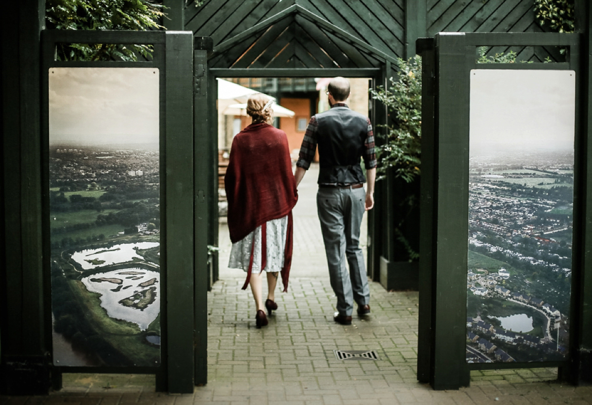 Gillian wore a short lace John Lewis wedding dress and a feather in her hair for her nature inspired Autumn wedding at London Wetlands Centre. Images by Kristida Photography.