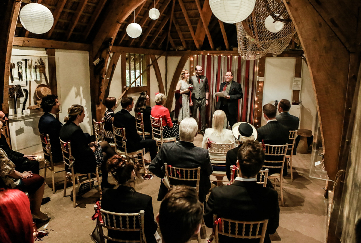 Gillian wore a short lace John Lewis wedding dress and a feather in her hair for her nature inspired Autumn wedding at London Wetlands Centre. Images by Kristida Photography.