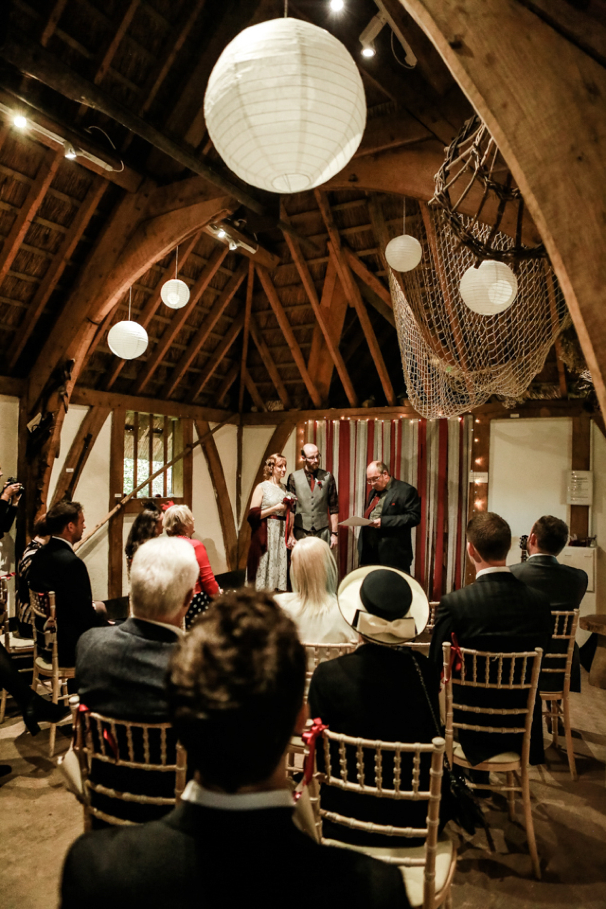 Gillian wore a short lace John Lewis wedding dress and a feather in her hair for her nature inspired Autumn wedding at London Wetlands Centre. Images by Kristida Photography.