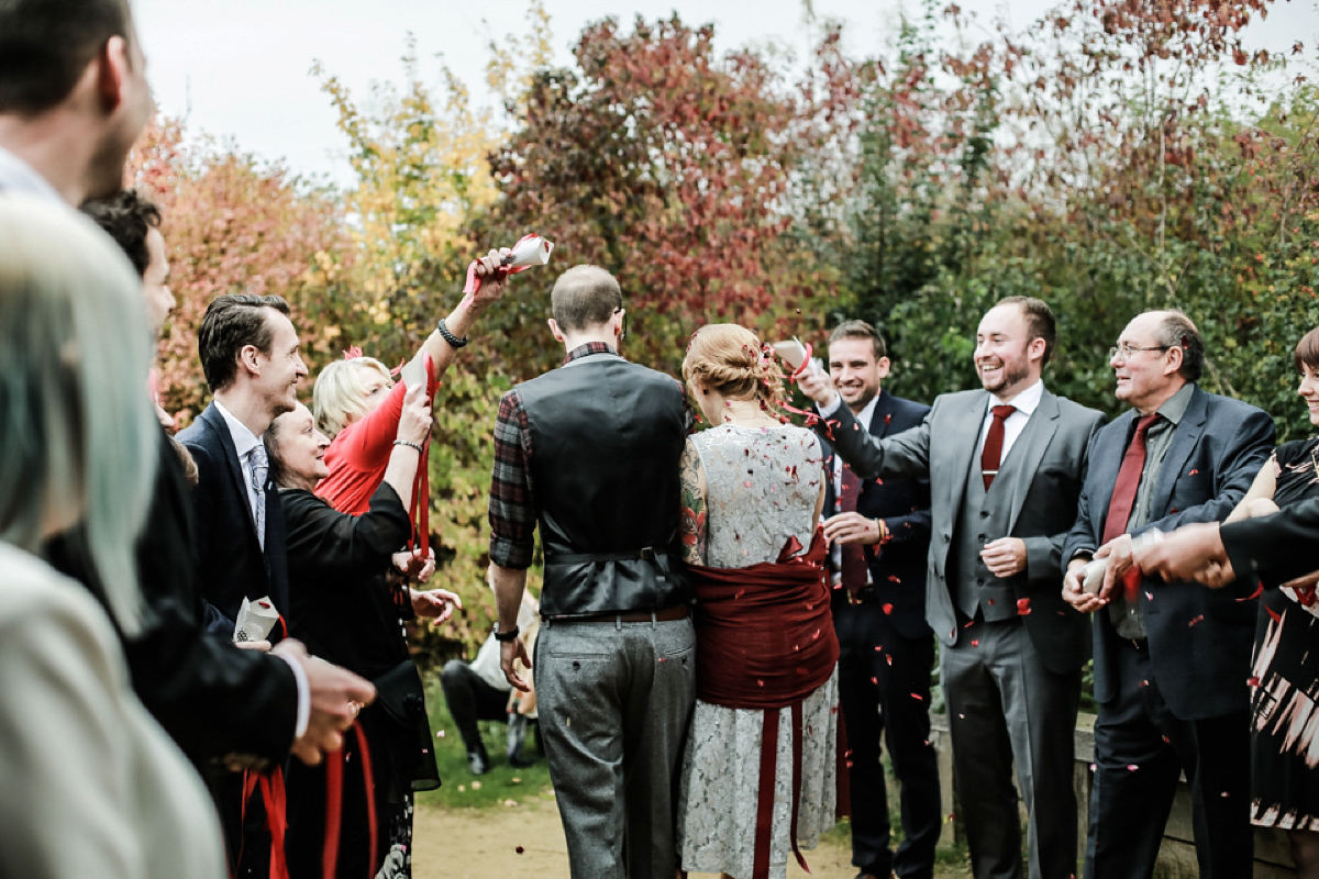 Gillian wore a short lace John Lewis wedding dress and a feather in her hair for her nature inspired Autumn wedding at London Wetlands Centre. Images by Kristida Photography.