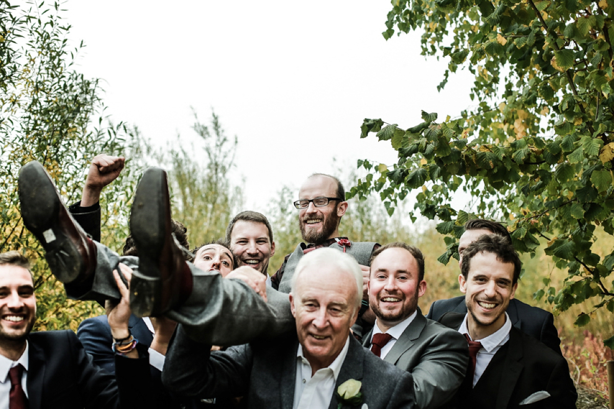 Gillian wore a short lace John Lewis wedding dress and a feather in her hair for her nature inspired Autumn wedding at London Wetlands Centre. Images by Kristida Photography.