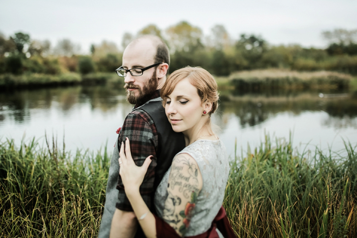 Gillian wore a short lace John Lewis wedding dress and a feather in her hair for her nature inspired Autumn wedding at London Wetlands Centre. Images by Kristida Photography.