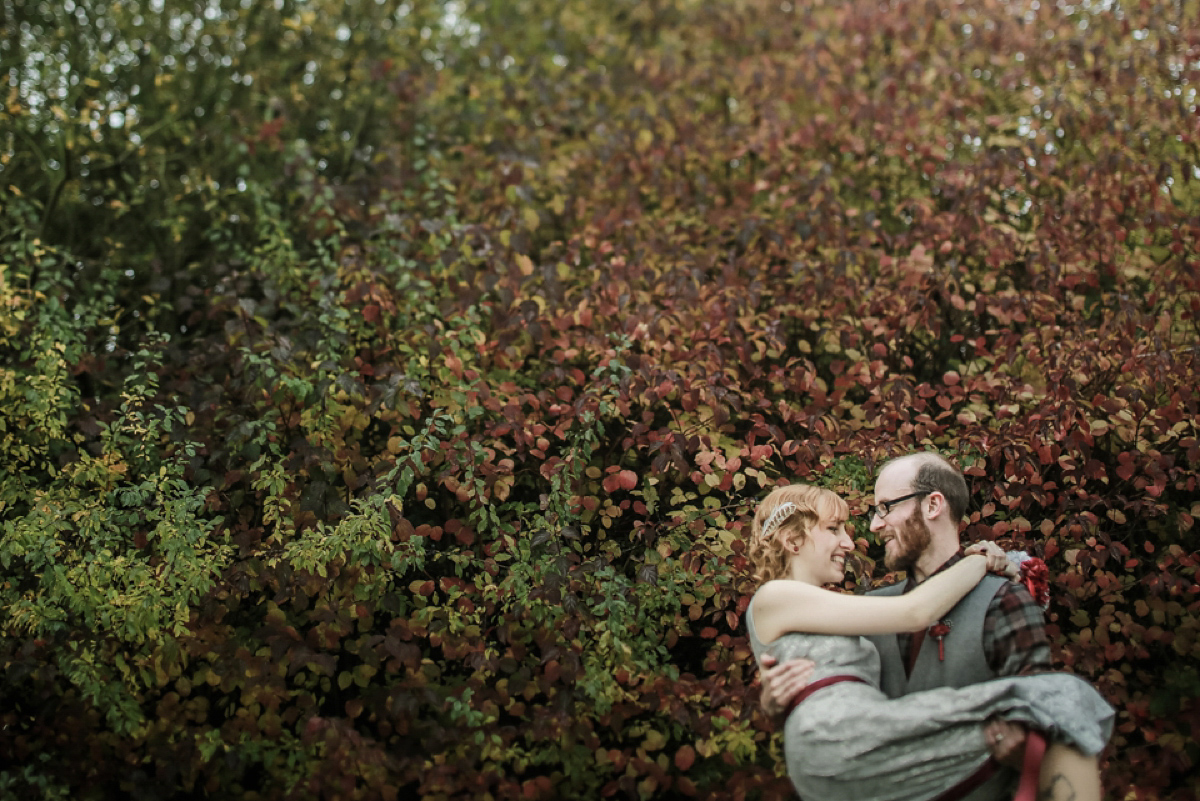 Gillian wore a short lace John Lewis wedding dress and a feather in her hair for her nature inspired Autumn wedding at London Wetlands Centre. Images by Kristida Photography.