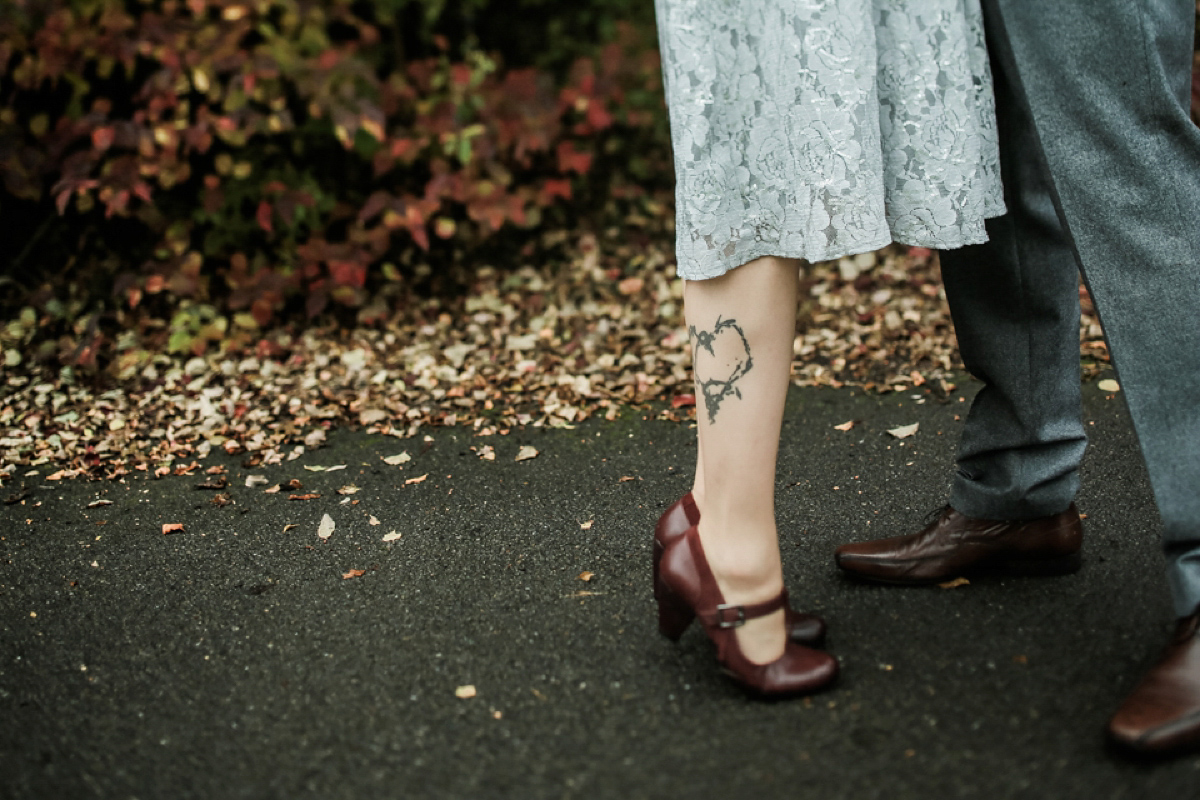 Gillian wore a short lace John Lewis wedding dress and a feather in her hair for her nature inspired Autumn wedding at London Wetlands Centre. Images by Kristida Photography.