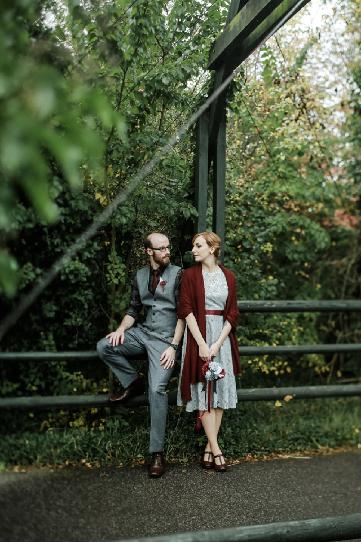 Gillian wore a short lace John Lewis wedding dress and a feather in her hair for her nature inspired Autumn wedding at London Wetlands Centre. Images by Kristida Photography.