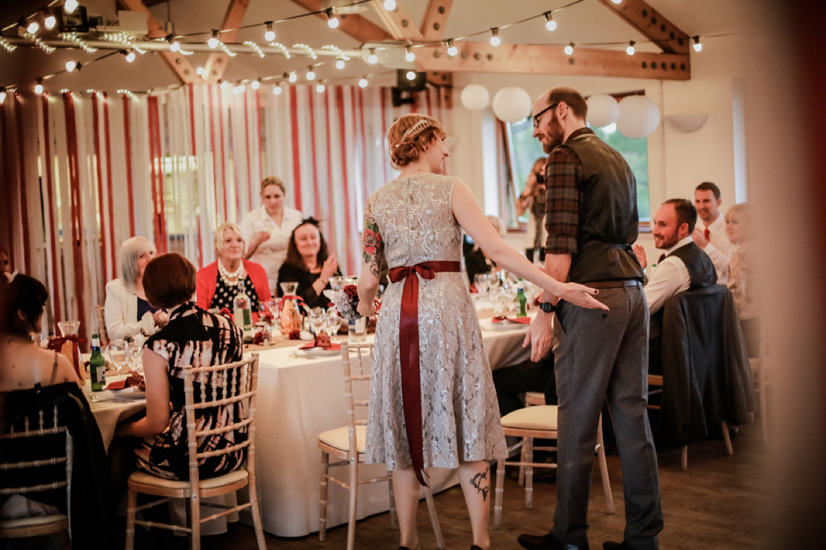 Gillian wore a short lace John Lewis wedding dress and a feather in her hair for her nature inspired Autumn wedding at London Wetlands Centre. Images by Kristida Photography.