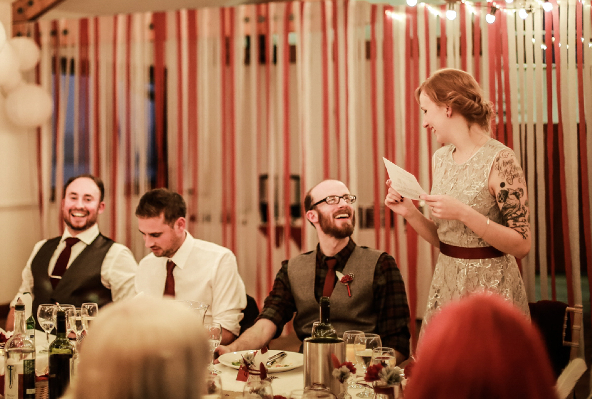 Gillian wore a short lace John Lewis wedding dress and a feather in her hair for her nature inspired Autumn wedding at London Wetlands Centre. Images by Kristida Photography.