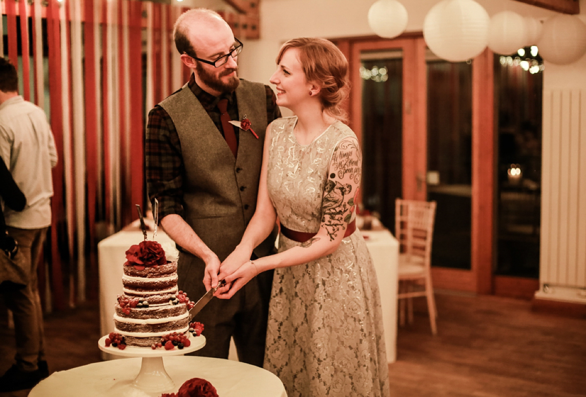 Gillian wore a short lace John Lewis wedding dress and a feather in her hair for her nature inspired Autumn wedding at London Wetlands Centre. Images by Kristida Photography.