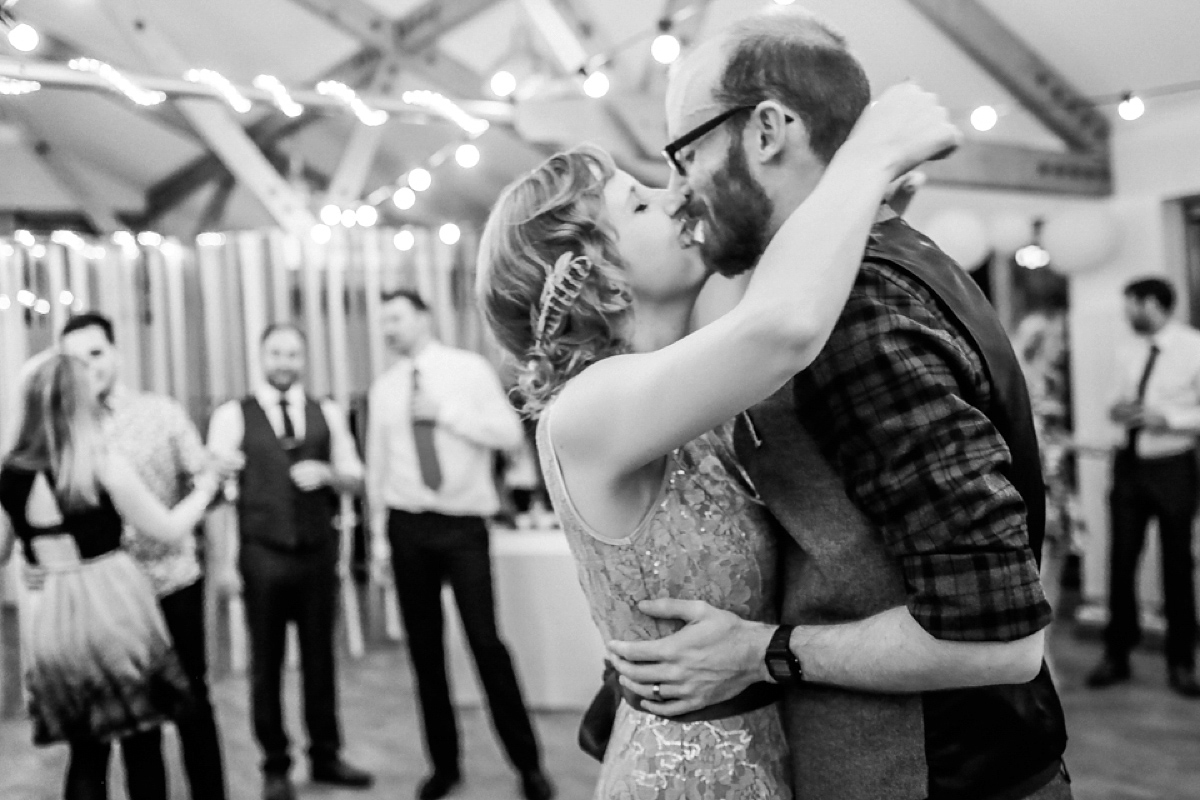 Gillian wore a short lace John Lewis wedding dress and a feather in her hair for her nature inspired Autumn wedding at London Wetlands Centre. Images by Kristida Photography.