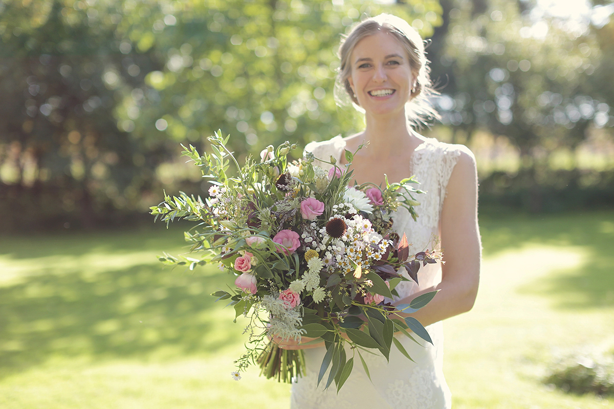 Ellie's wears a 1920's drop waist vintage dress for her outdoor, Autumn, Humanist wedding ceremony at Dewsall Court. Images by Bullit Photography.