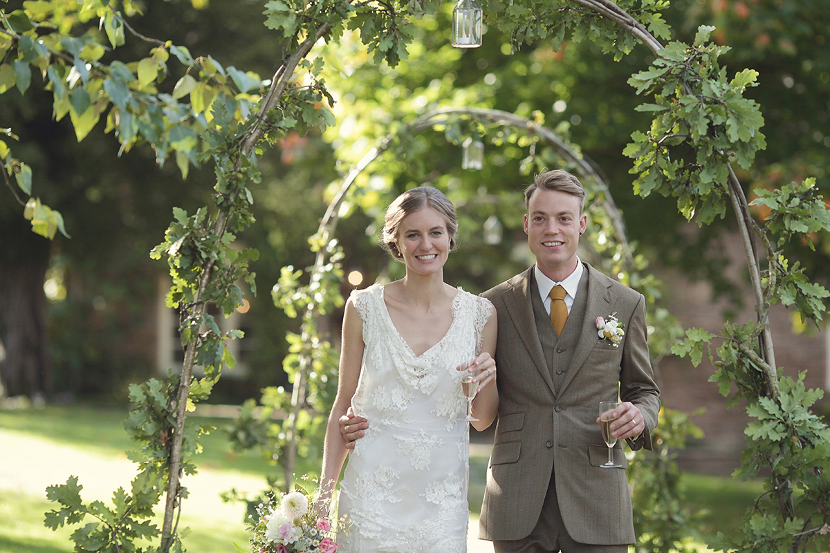 Ellie's wears a 1920's drop waist vintage dress for her outdoor, Autumn, Humanist wedding ceremony at Dewsall Court. Images by Bullit Photography.