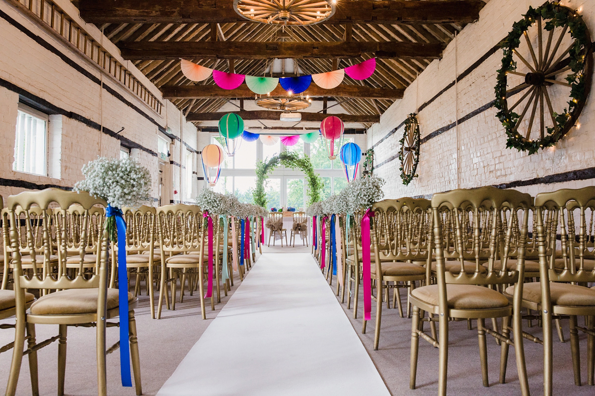 Liz wore a Vivienne Westwood dress for her hot air balloon and travel inspired wedding ('Around the World in 80 Days', Phileas Fogg style). A Lillibrooke Hall summer barn wedding, photographed by Faye Cornhill.