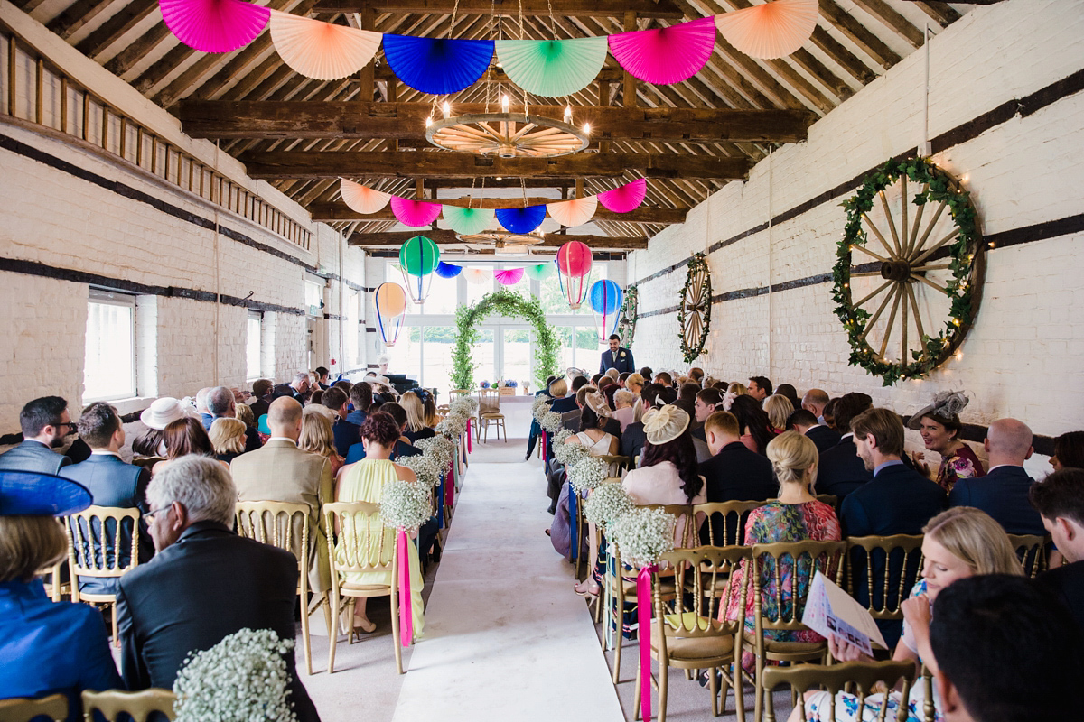 Liz wore a Vivienne Westwood dress for her hot air balloon and travel inspired wedding ('Around the World in 80 Days', Phileas Fogg style). A Lillibrooke Hall summer barn wedding, photographed by Faye Cornhill.