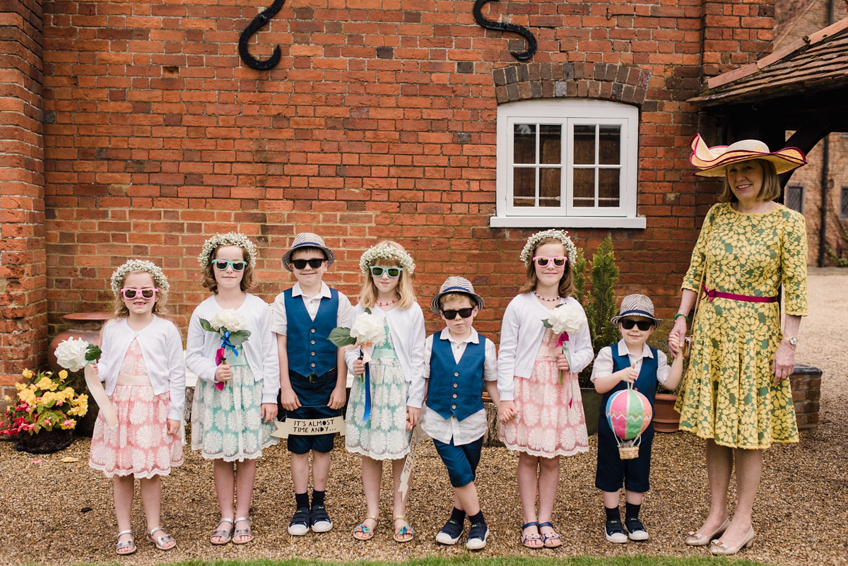 Liz wore a Vivienne Westwood dress for her hot air balloon and travel inspired wedding ('Around the World in 80 Days', Phileas Fogg style). A Lillibrooke Hall summer barn wedding, photographed by Faye Cornhill.