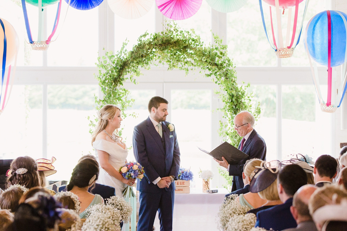 Liz wore a Vivienne Westwood dress for her hot air balloon and travel inspired wedding ('Around the World in 80 Days', Phileas Fogg style). A Lillibrooke Hall summer barn wedding, photographed by Faye Cornhill.