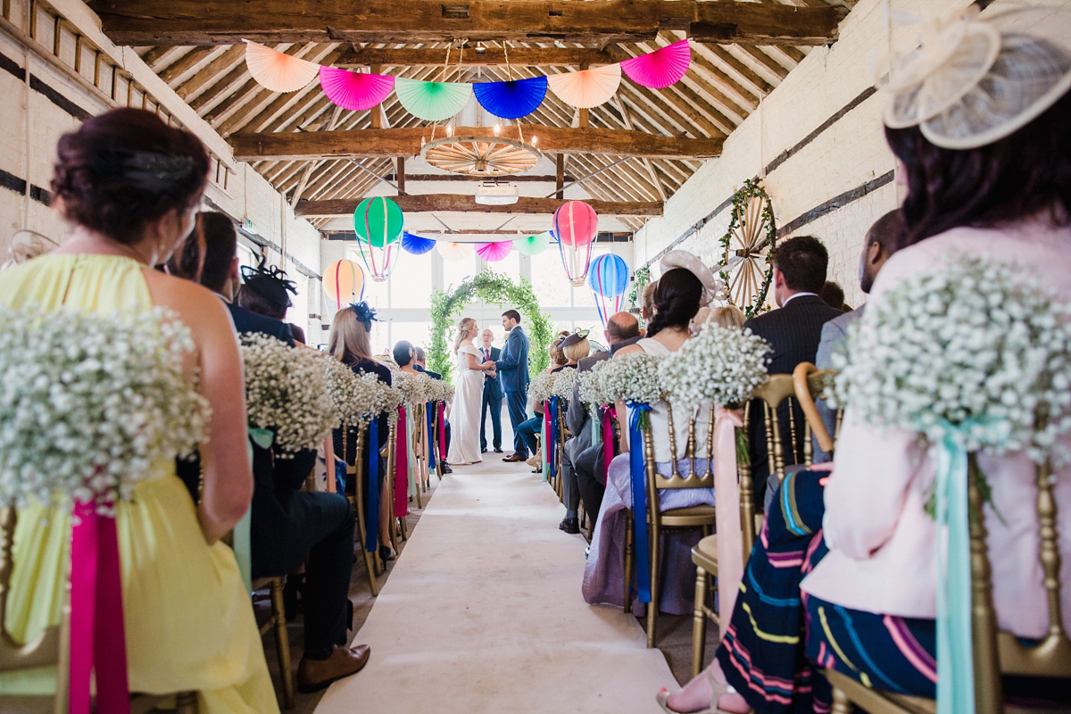 Liz wore a Vivienne Westwood dress for her hot air balloon and travel inspired wedding ('Around the World in 80 Days', Phileas Fogg style). A Lillibrooke Hall summer barn wedding, photographed by Faye Cornhill.