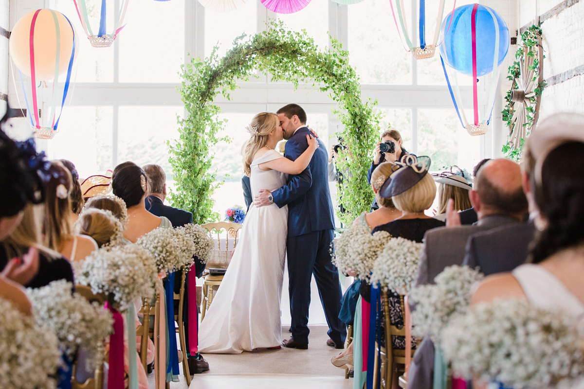 Liz wore a Vivienne Westwood dress for her hot air balloon and travel inspired wedding ('Around the World in 80 Days', Phileas Fogg style). A Lillibrooke Hall summer barn wedding, photographed by Faye Cornhill.