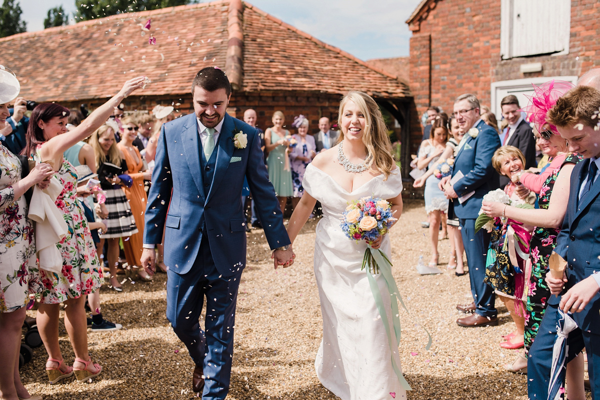 Liz wore a Vivienne Westwood dress for her hot air balloon and travel inspired wedding ('Around the World in 80 Days', Phileas Fogg style). A Lillibrooke Hall summer barn wedding, photographed by Faye Cornhill.