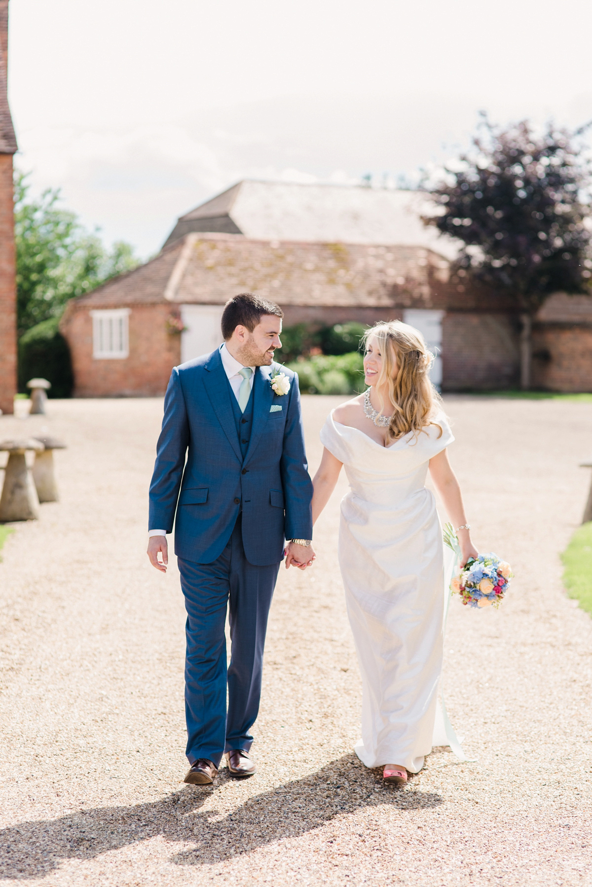 Liz wore a Vivienne Westwood dress for her hot air balloon and travel inspired wedding ('Around the World in 80 Days', Phileas Fogg style). A Lillibrooke Hall summer barn wedding, photographed by Faye Cornhill.