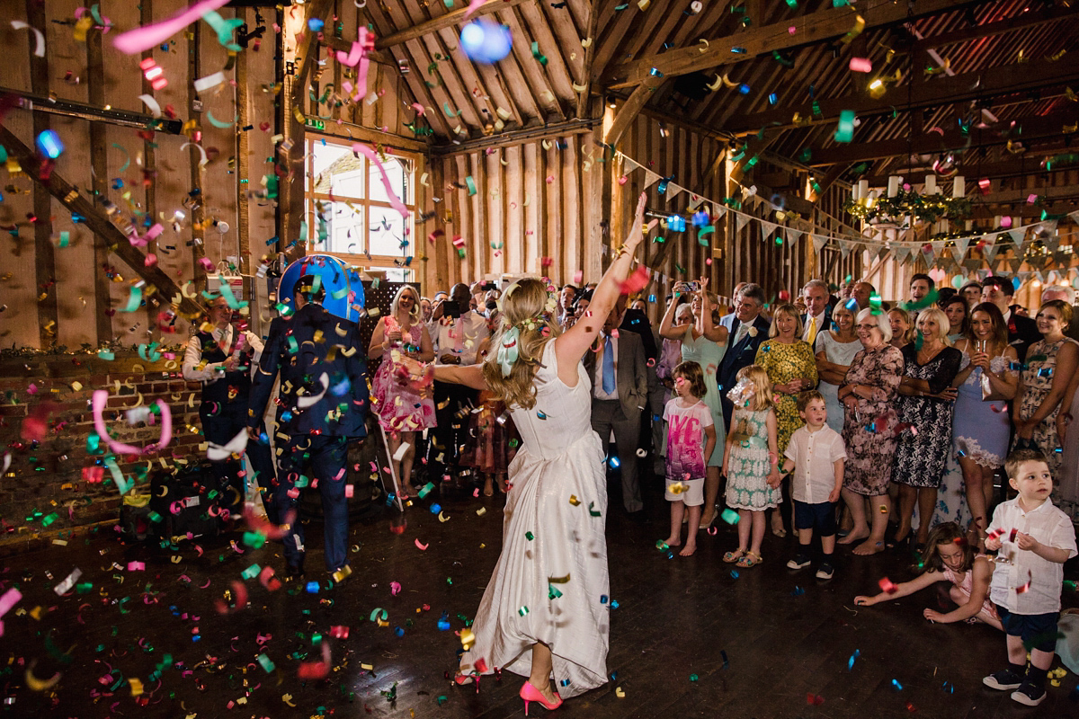 Liz wore a Vivienne Westwood dress for her hot air balloon and travel inspired wedding ('Around the World in 80 Days', Phileas Fogg style). A Lillibrooke Hall summer barn wedding, photographed by Faye Cornhill.