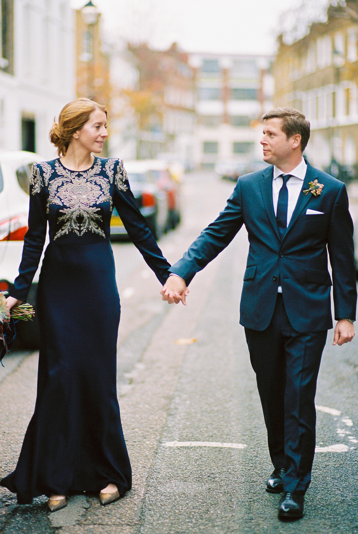 Leanne wears a navy blue Alexander McQueen dress for her modern and stylish, non traditional London wedding. A First look wedding captured on film by Peachey Photography.