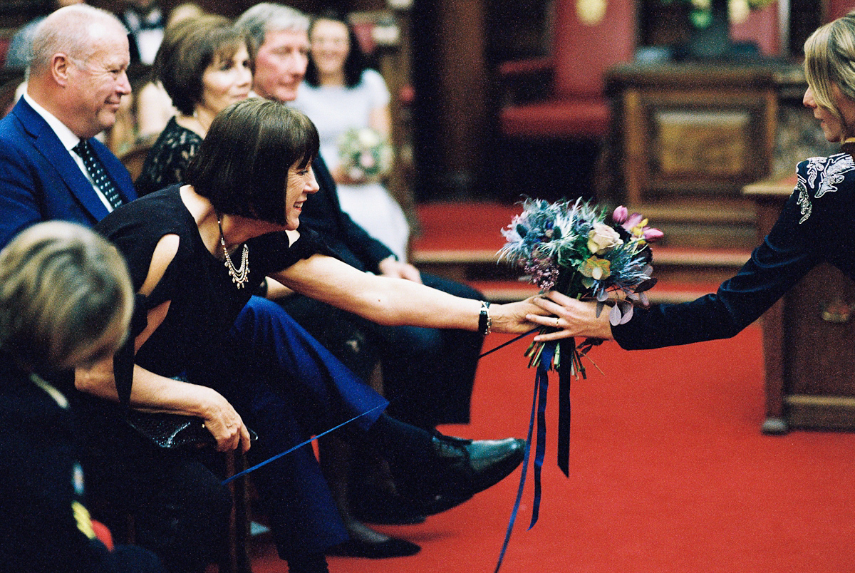 Leanne wears a navy blue Alexander McQueen dress for her modern and stylish, non traditional London wedding. A First look wedding captured on film by Peachey Photography.