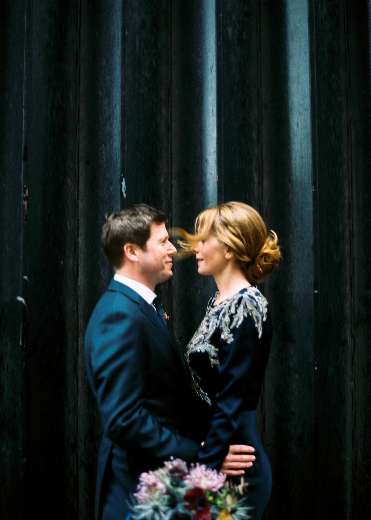 Leanne wears a navy blue Alexander McQueen dress for her modern and stylish, non traditional London wedding. A First look wedding captured on film by Peachey Photography.