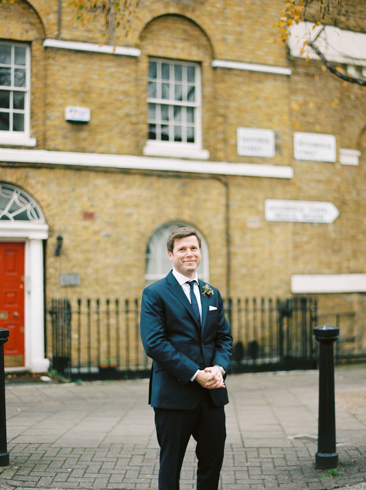 Leanne wears a navy blue Alexander McQueen dress for her modern and stylish, non traditional London wedding. A First look wedding captured on film by Peachey Photography.