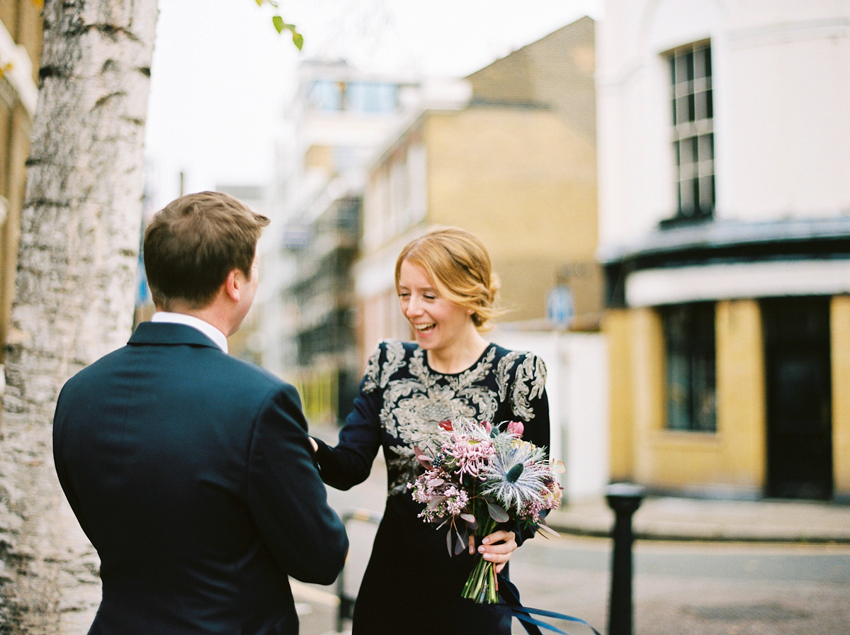 Leanne wears a navy blue Alexander McQueen dress for her modern and stylish, non traditional London wedding. A First look wedding captured on film by Peachey Photography.