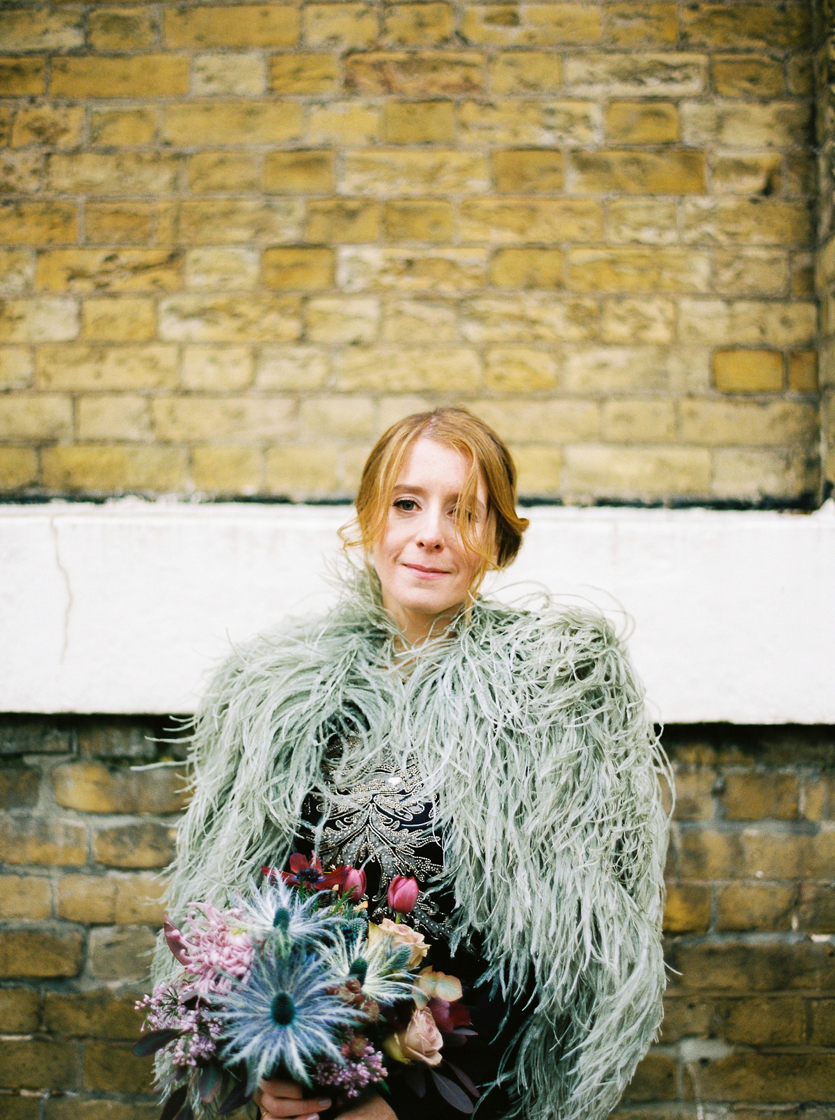 Leanne wears a navy blue Alexander McQueen dress for her modern and stylish, non traditional London wedding. A First look wedding captured on film by Peachey Photography.