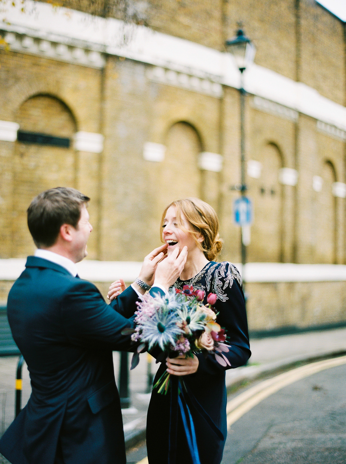 Leanne wears a navy blue Alexander McQueen dress for her modern and stylish, non traditional London wedding. A First look wedding captured on film by Peachey Photography.