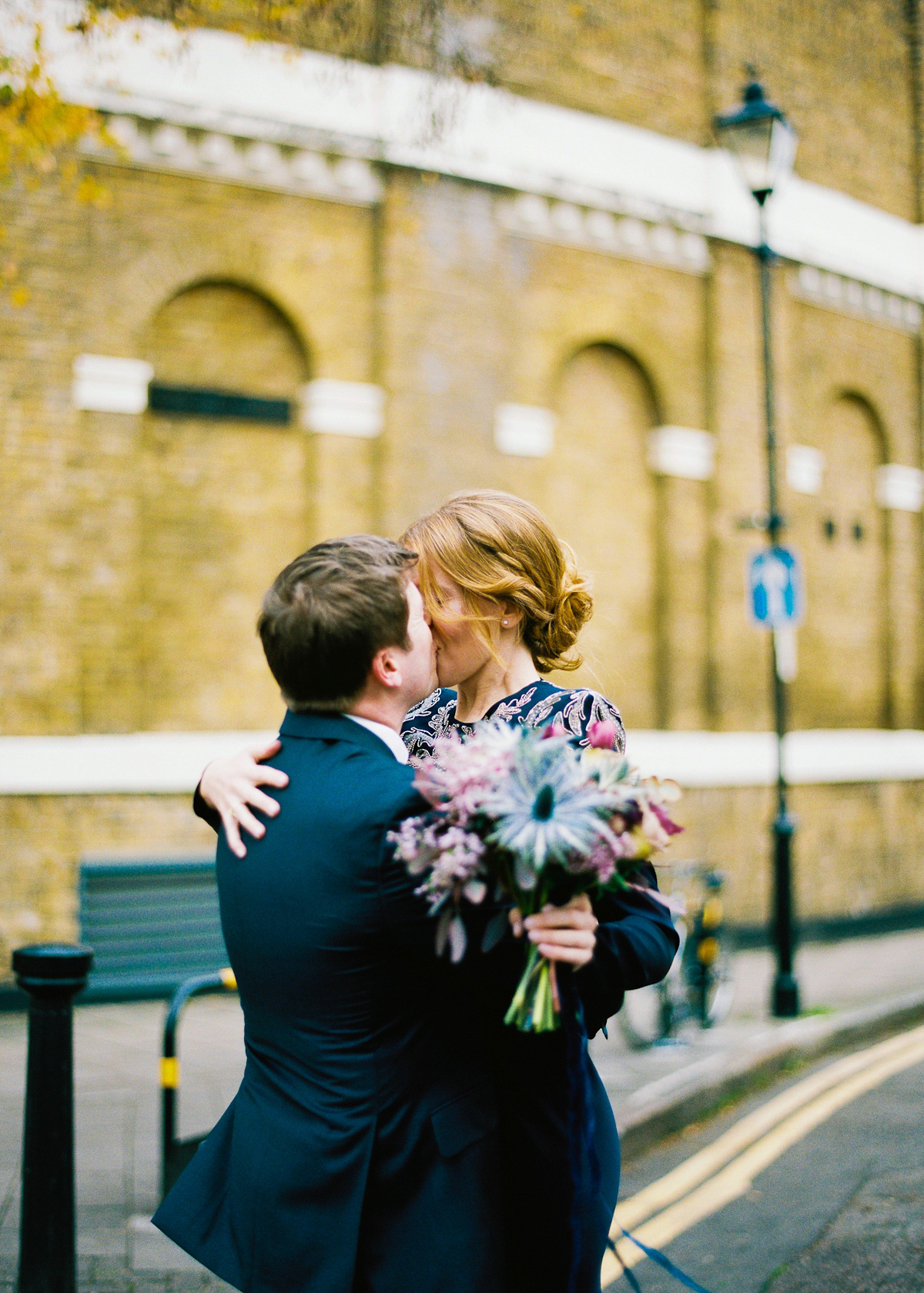 Leanne wears a navy blue Alexander McQueen dress for her modern and stylish, non traditional London wedding. A First look wedding captured on film by Peachey Photography.