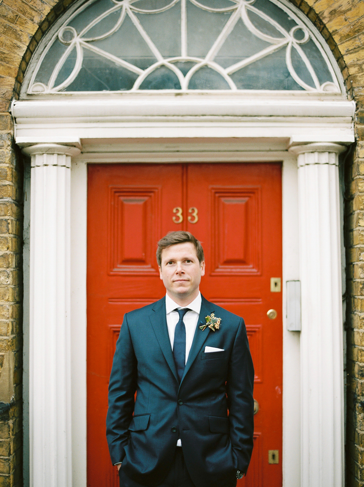 Leanne wears a navy blue Alexander McQueen dress for her modern and stylish, non traditional London wedding. A First look wedding captured on film by Peachey Photography.