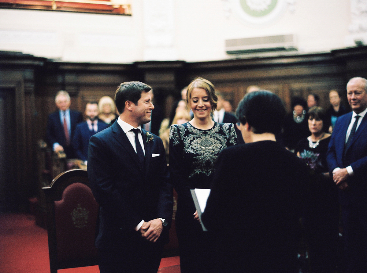 Leanne wears a navy blue Alexander McQueen dress for her modern and stylish, non traditional London wedding. A First look wedding captured on film by Peachey Photography.