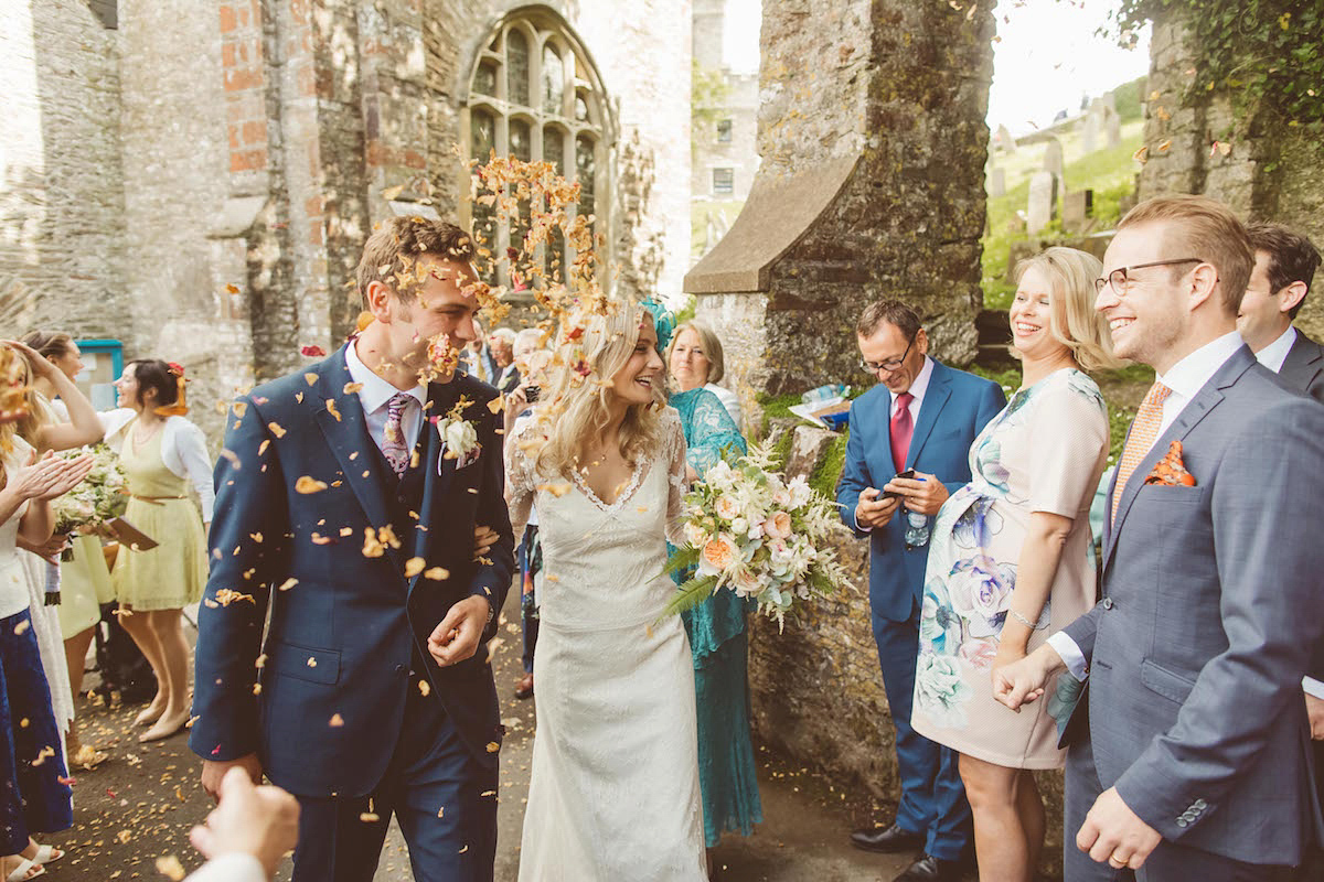 Bride Anna wore a feminine and bohemian inspired Rembo Styling dress for her wedding at her husbands family home in Devon. Photography by Jay Rowden.