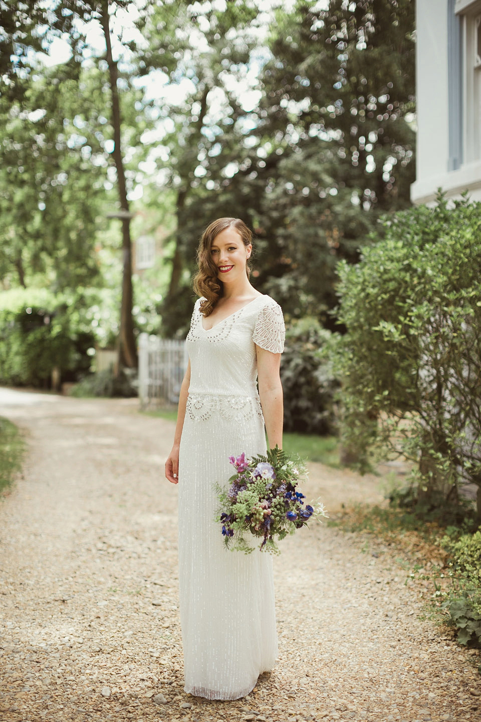 Bride Alison wears a beaded Eliza Jane Howell wedding dress for her glamorous and whimsical summer wedding. Captured by Tom Ravenshear Phtography.