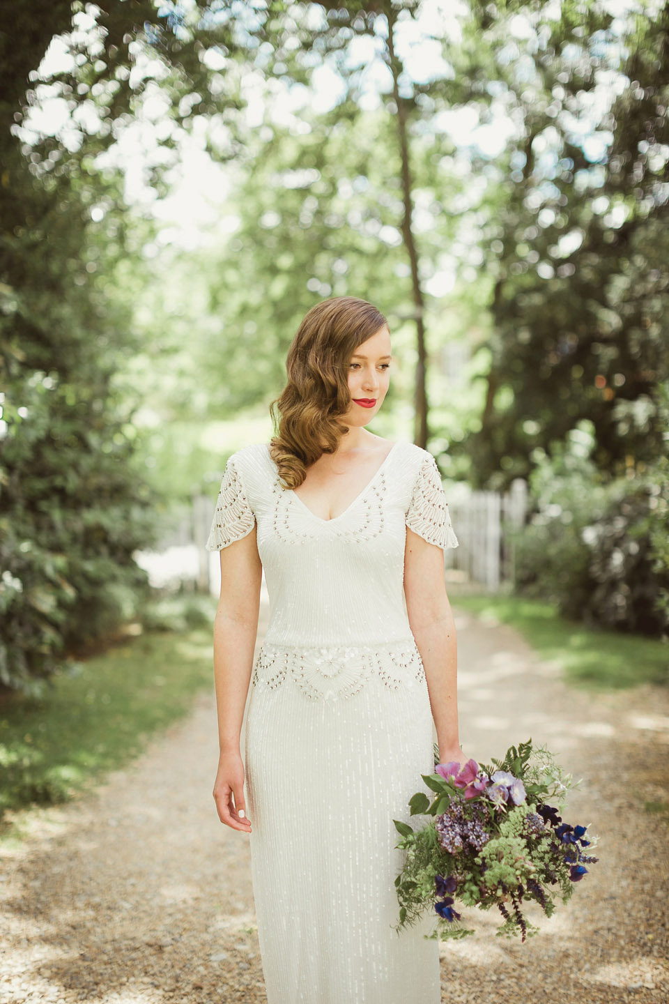 Bride Alison wears a beaded Eliza Jane Howell wedding dress for her glamorous and whimsical summer wedding. Captured by Tom Ravenshear Phtography.