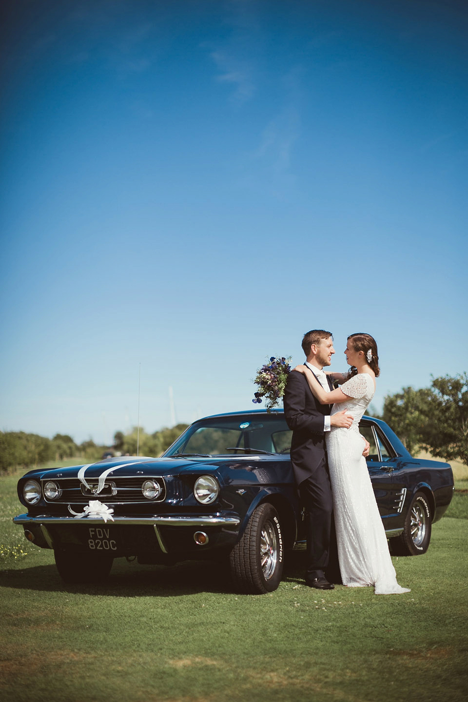 Bride Alison wears a beaded Eliza Jane Howell wedding dress for her glamorous and whimsical summer wedding. Captured by Tom Ravenshear Phtography.