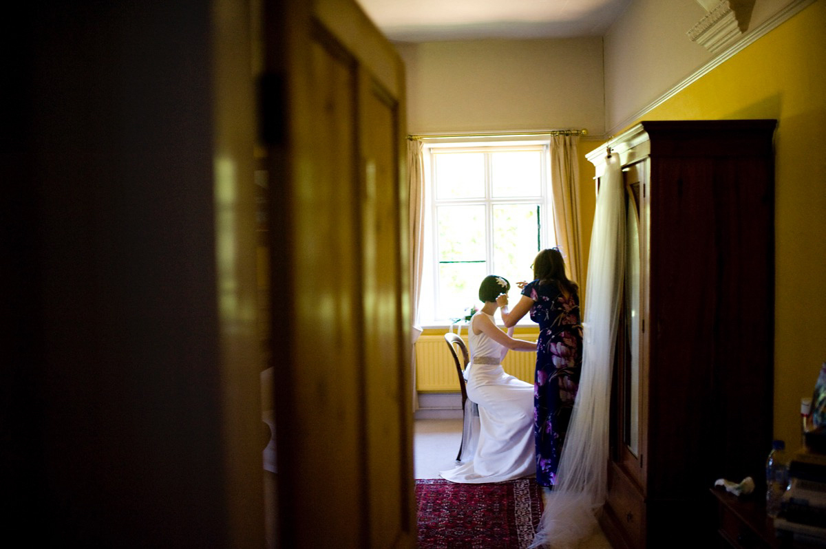 Bride Alice wore a chic, Charlie Brear column style gown for her 1920's and books/literary inspired summer barn wedding. Images by Richard Beaumont.