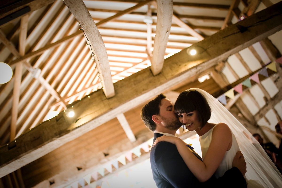 Bride Alice wore a chic, Charlie Brear column style gown for her 1920's and books/literary inspired summer barn wedding. Images by Richard Beaumont.