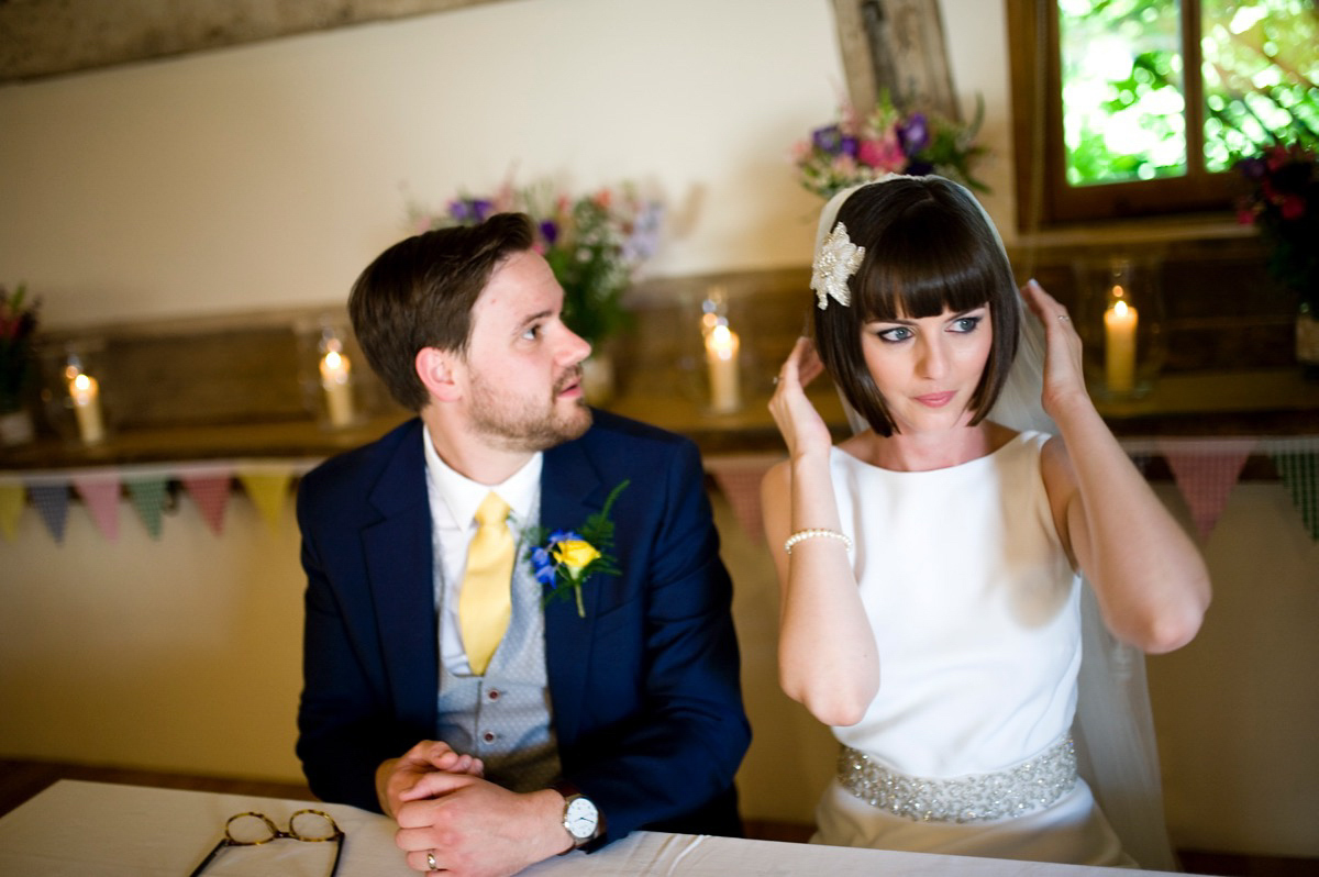 Bride Alice wore a chic, Charlie Brear column style gown for her 1920's and books/literary inspired summer barn wedding. Images by Richard Beaumont.