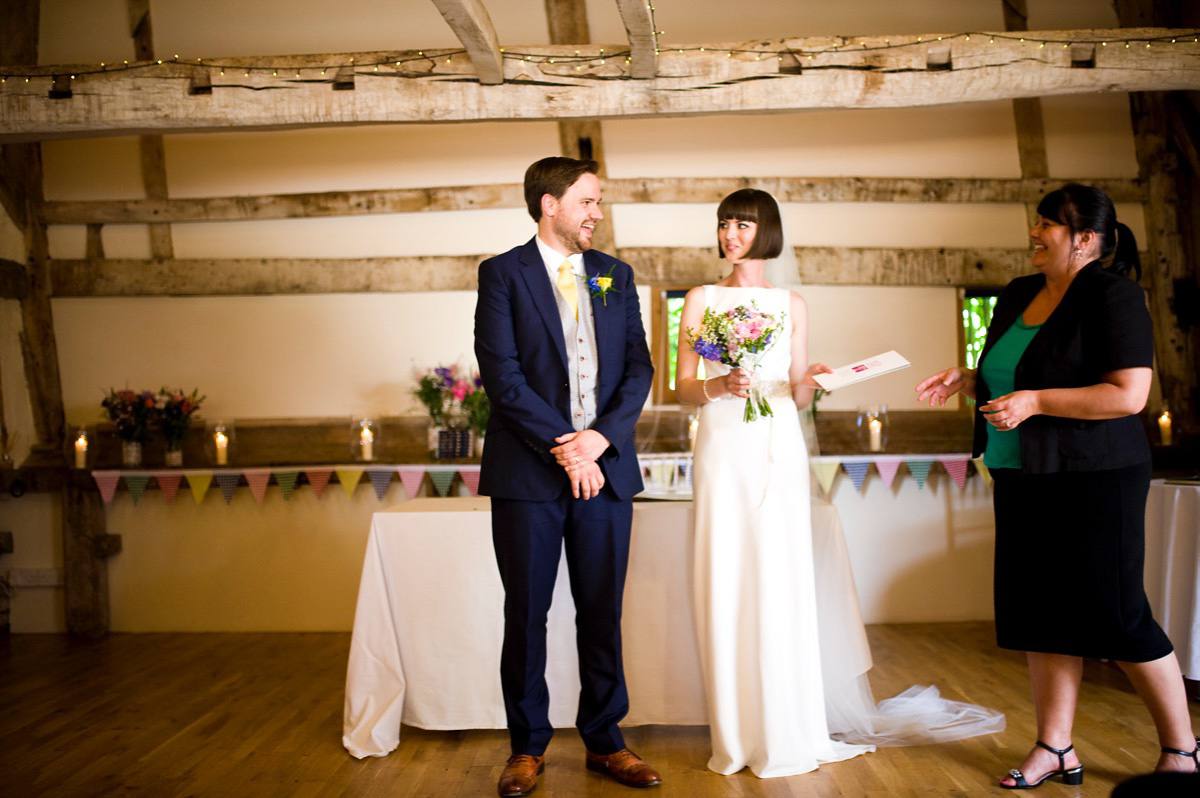 Bride Alice wore a chic, Charlie Brear column style gown for her 1920's and books/literary inspired summer barn wedding. Images by Richard Beaumont.