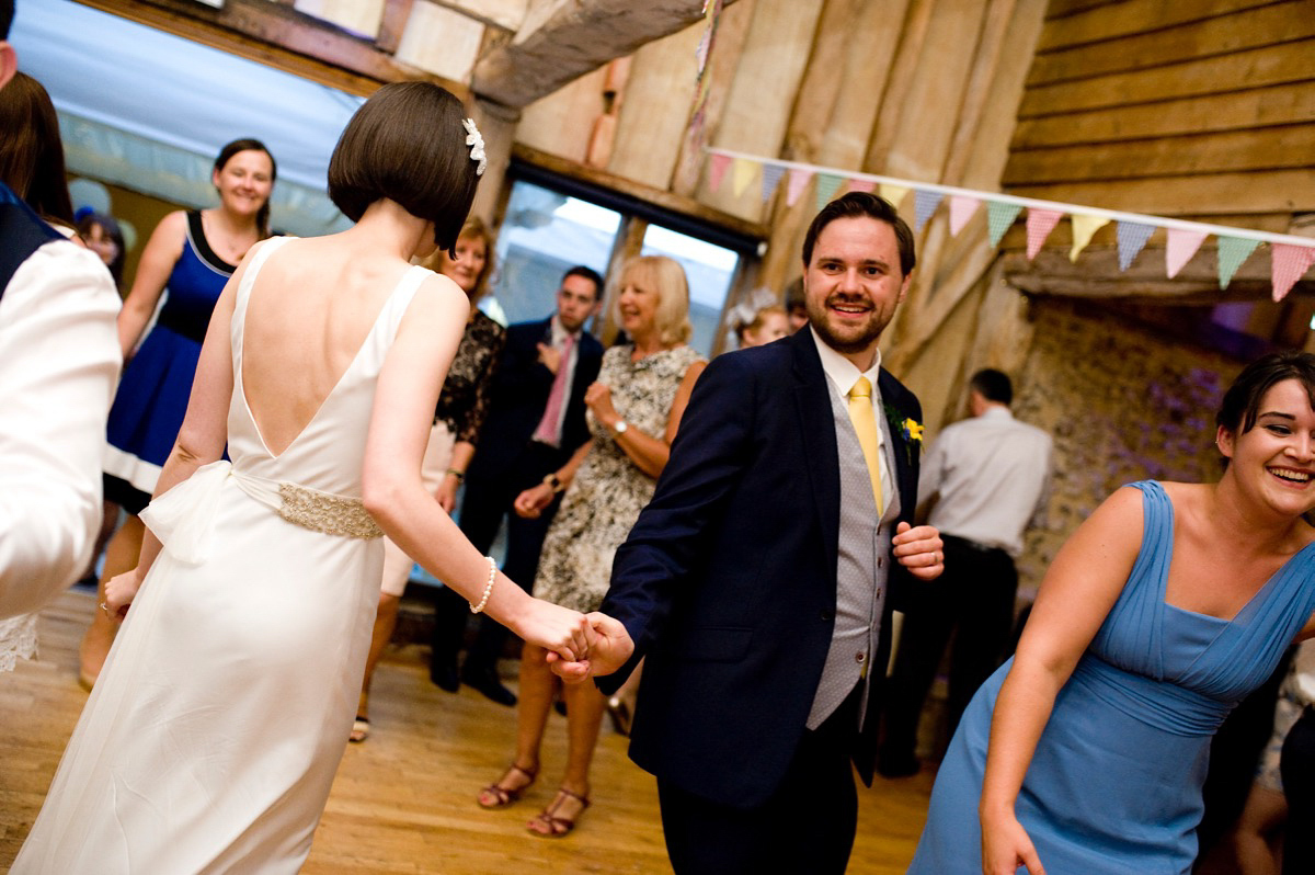 Bride Alice wore a chic, Charlie Brear column style gown for her 1920's and books/literary inspired summer barn wedding. Images by Richard Beaumont.