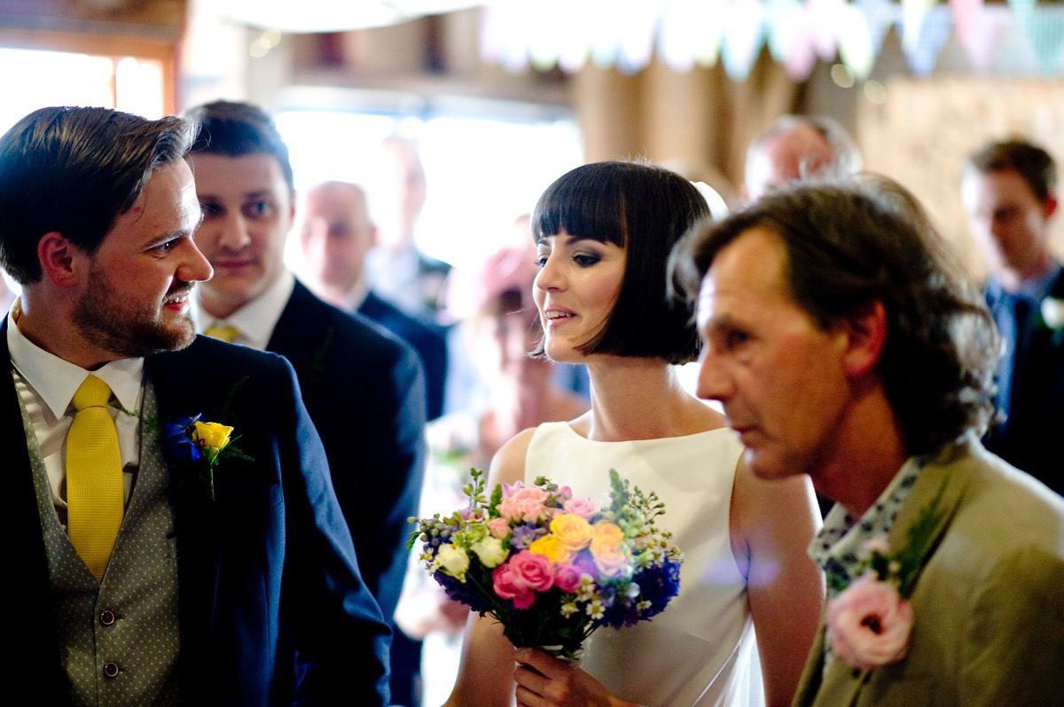 Bride Alice wore a chic, Charlie Brear column style gown for her 1920's and books/literary inspired summer barn wedding. Images by Richard Beaumont.