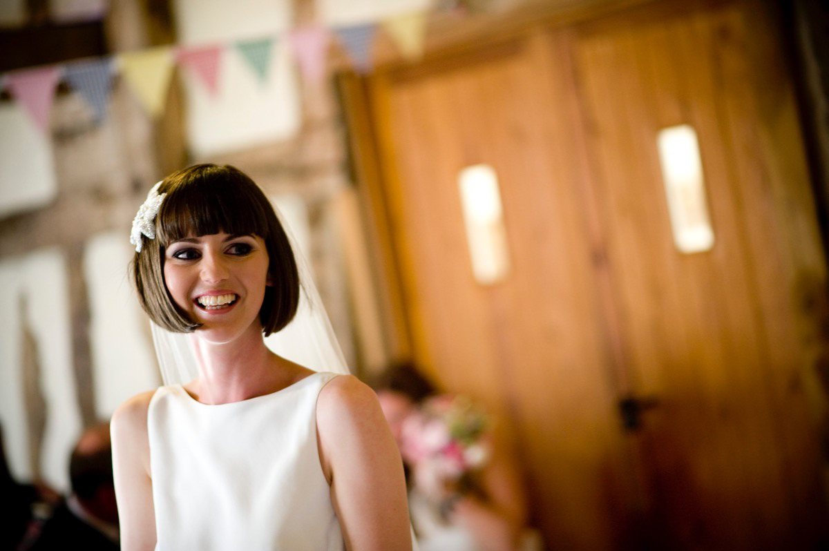 Bride Alice wore a chic, Charlie Brear column style gown for her 1920's and books/literary inspired summer barn wedding. Images by Richard Beaumont.