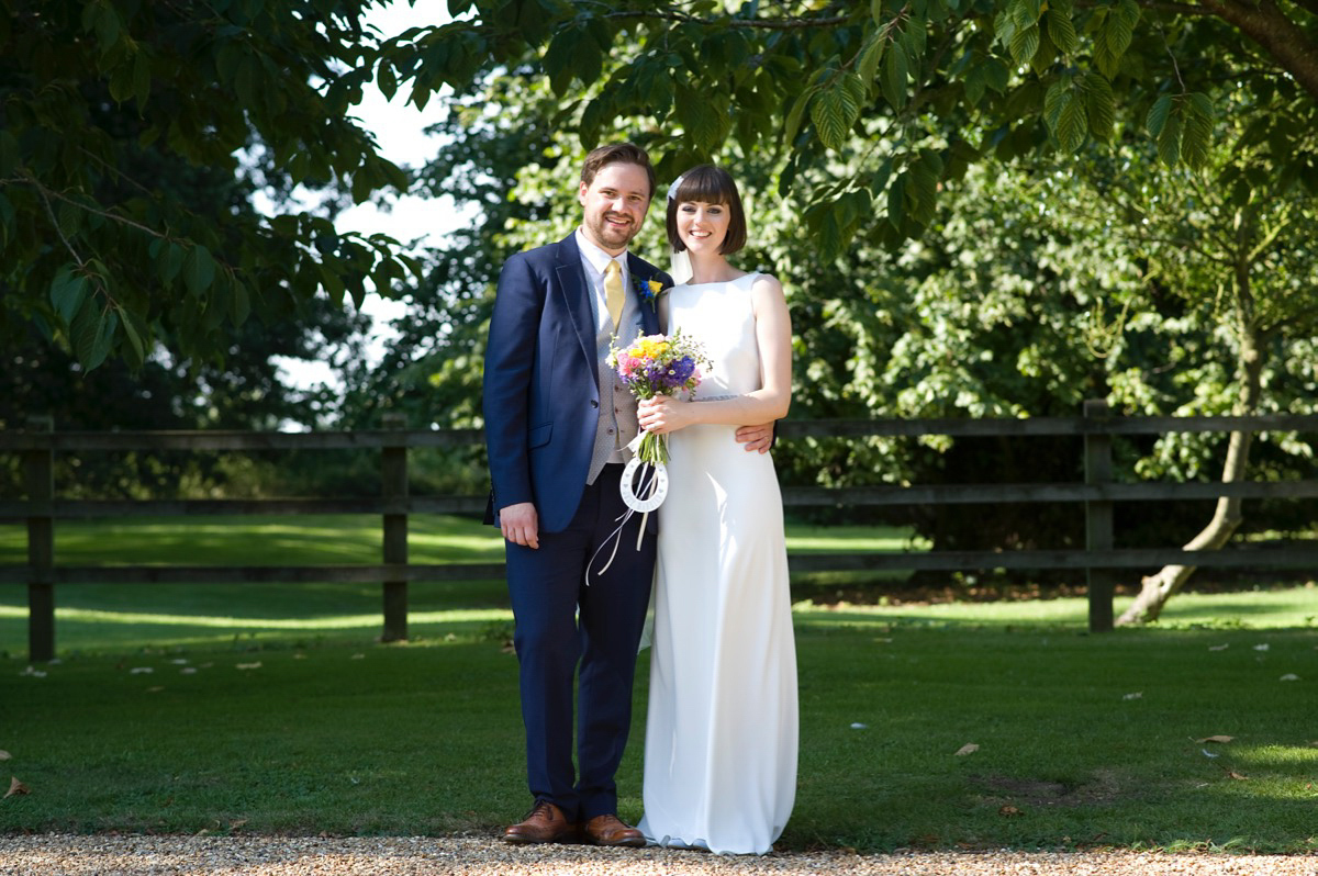 Bride Alice wore a chic, Charlie Brear column style gown for her 1920's and books/literary inspired summer barn wedding. Images by Richard Beaumont.